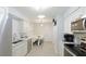 Modern kitchen featuring white cabinets, stainless steel appliances, and marble countertops at 6726 S Lockwood Ridge Rd, Sarasota, FL 34231