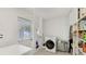 Laundry room with washer, dryer, storage, and exterior access at 6726 S Lockwood Ridge Rd, Sarasota, FL 34231