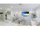 Spacious living room featuring white sofas and a large TV at 6726 S Lockwood Ridge Rd, Sarasota, FL 34231