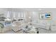 Living area with white sofas, large windows, and a TV at 6726 S Lockwood Ridge Rd, Sarasota, FL 34231