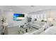 Living room featuring white sofas and a large TV at 6726 S Lockwood Ridge Rd, Sarasota, FL 34231