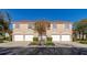 Three-unit building, tan exterior, white garage doors, and landscaping at 7107 Cedar Hollow Cir, Bradenton, FL 34203