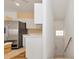Kitchen area with stainless steel appliances and stairs to entry at 7107 Cedar Hollow Cir, Bradenton, FL 34203