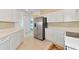 White kitchen cabinets, stainless steel appliances, and ample counter space at 7107 Cedar Hollow Cir, Bradenton, FL 34203