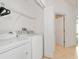 Bright laundry room with washer, dryer, and shelving at 7107 Cedar Hollow Cir, Bradenton, FL 34203