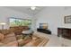 Living room with sectional sofa, access to balcony, and large TV at 7107 Cedar Hollow Cir, Bradenton, FL 34203