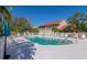 Community pool with lounge chairs and umbrellas at 7107 Cedar Hollow Cir, Bradenton, FL 34203