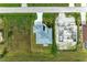 Aerial view showing a completed house next to one under construction at 75 Mark Twain Ln, Rotonda West, FL 33947