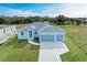 New construction home with a three-car garage and spacious lawn at 75 Mark Twain Ln, Rotonda West, FL 33947