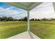 Covered patio overlooks a spacious grassy backyard at 75 Mark Twain Ln, Rotonda West, FL 33947