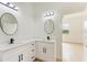 Modern bathroom with double vanity and white cabinets at 75 Mark Twain Ln, Rotonda West, FL 33947