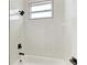 Clean bathroom with shower/tub combo and a window at 75 Mark Twain Ln, Rotonda West, FL 33947