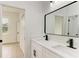 Modern bathroom with double vanity and a large mirror at 75 Mark Twain Ln, Rotonda West, FL 33947