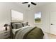 Serene bedroom with olive green bedding and ample natural light at 75 Mark Twain Ln, Rotonda West, FL 33947
