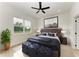 Spacious bedroom with plush bed, large window and ceiling fan at 75 Mark Twain Ln, Rotonda West, FL 33947