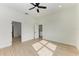 Bright bedroom with wood-look floors and ceiling fan at 75 Mark Twain Ln, Rotonda West, FL 33947