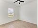 Spacious bedroom with wood-look floors and window at 75 Mark Twain Ln, Rotonda West, FL 33947