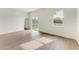 Bright bedroom with wood-look flooring and sliding glass door to patio at 75 Mark Twain Ln, Rotonda West, FL 33947