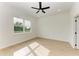 Spacious bedroom with ceiling fan and large window at 75 Mark Twain Ln, Rotonda West, FL 33947
