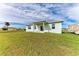 Newly built home with a light green exterior and a small patio at 75 Mark Twain Ln, Rotonda West, FL 33947