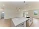Kitchen island with white quartz countertops and a stainless steel sink at 75 Mark Twain Ln, Rotonda West, FL 33947