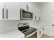 Stainless steel appliances and white shaker cabinets in this modern kitchen at 75 Mark Twain Ln, Rotonda West, FL 33947