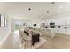 Open concept kitchen with island, white cabinets, and stainless steel appliances at 75 Mark Twain Ln, Rotonda West, FL 33947