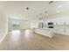 Modern white kitchen with an island and stainless steel appliances at 75 Mark Twain Ln, Rotonda West, FL 33947