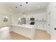 Modern kitchen with white cabinets, stainless steel appliances, and large island at 75 Mark Twain Ln, Rotonda West, FL 33947