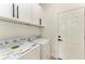 Laundry room with washer, dryer, and cabinets at 75 Mark Twain Ln, Rotonda West, FL 33947