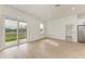 Open concept living area with light wood floors and sliding glass doors to patio at 75 Mark Twain Ln, Rotonda West, FL 33947