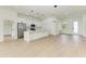 Open concept living space with light wood floors and access to the kitchen at 75 Mark Twain Ln, Rotonda West, FL 33947