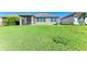 Large backyard with grassy area and screened patio at 7825 112Th E Ave, Parrish, FL 34219