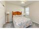 Bright bedroom with a floral bedspread, ceiling fan, and double door closet at 7825 112Th E Ave, Parrish, FL 34219