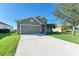 One-story house with a two-car garage and landscaped lawn at 7825 112Th E Ave, Parrish, FL 34219