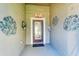Inviting front entry with decorative wall art and doormat at 7825 112Th E Ave, Parrish, FL 34219
