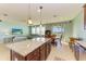 Open kitchen features granite island, breakfast nook, and view to living room at 7825 112Th E Ave, Parrish, FL 34219