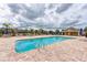 Community pool with plenty of seating and umbrellas at 7825 112Th E Ave, Parrish, FL 34219