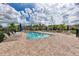 Community pool with lounge chairs and umbrellas at 7825 112Th E Ave, Parrish, FL 34219