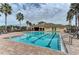 Community pool and clubhouse with surrounding chairs at 7825 112Th E Ave, Parrish, FL 34219