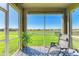 Relaxing screened porch overlooking a lake and green space at 7825 112Th E Ave, Parrish, FL 34219
