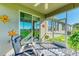 Spacious screened-in porch with comfy seating and a peaceful view at 7825 112Th E Ave, Parrish, FL 34219