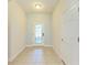Bright and airy entryway with tile flooring and a glass door at 7923 111Th E Ter, Parrish, FL 34219