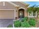Front entrance with lush landscaping and an arched entryway at 7923 111Th E Ter, Parrish, FL 34219