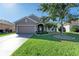Front yard with landscaping and a two-car garage at 7923 111Th E Ter, Parrish, FL 34219