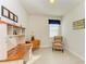 Bright home office features built-in shelving and a comfortable armchair at 7923 111Th E Ter, Parrish, FL 34219