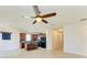 Open concept living and kitchen area with ceiling fan and island at 7923 111Th E Ter, Parrish, FL 34219