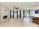 Open living space with tile floors, fireplace, and kitchen access at 7923 111Th E Ter, Parrish, FL 34219