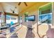 Relaxing screened porch with patio furniture and ceiling fan at 7923 111Th E Ter, Parrish, FL 34219