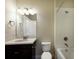 Bathroom with dark vanity, white tile, and bathtub at 8199 Varenna Dr, Sarasota, FL 34231